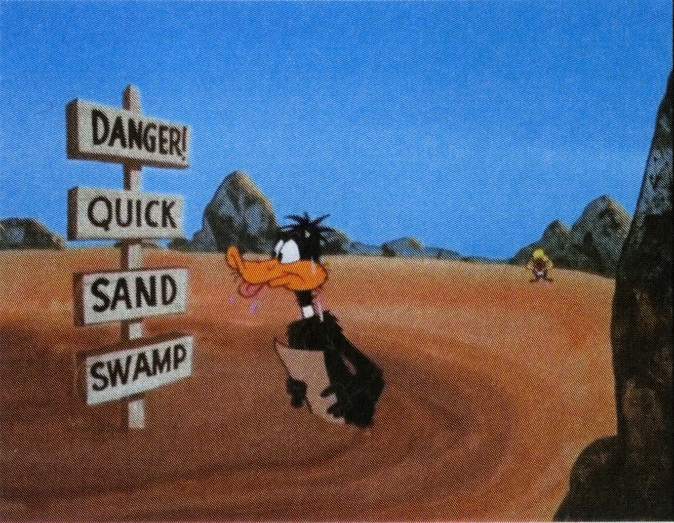 While looking at the map that says to left to the swamp, Daffy looks at the sign that say 